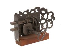 A 17th Century English Iron Door Lock, finely ornamented, with original operating key to one side,