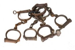 Five Pairs of 19th Century and Later Steel Handcuffs, including screw key examples