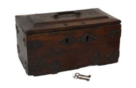 An 18th Century Oak Iron-Bound Chest, the hinged lid carved and dated 1733 above a substantial