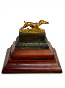 A 19th century French gilt bronze and patinated encrier or inkwell in form of a running hound