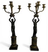 A pair of late 19th century French Empire style patinated and gilt bronze three light candelabra in