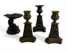 Three 19th century Grand Tour style bronze candlesticks and a small bronze shell dolphin tazza