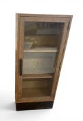A 1920's limed oak single door glazed bookcase,
