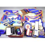 A large collection of Masonic memorabilia to include aprons, sashes, jewels to include some silver