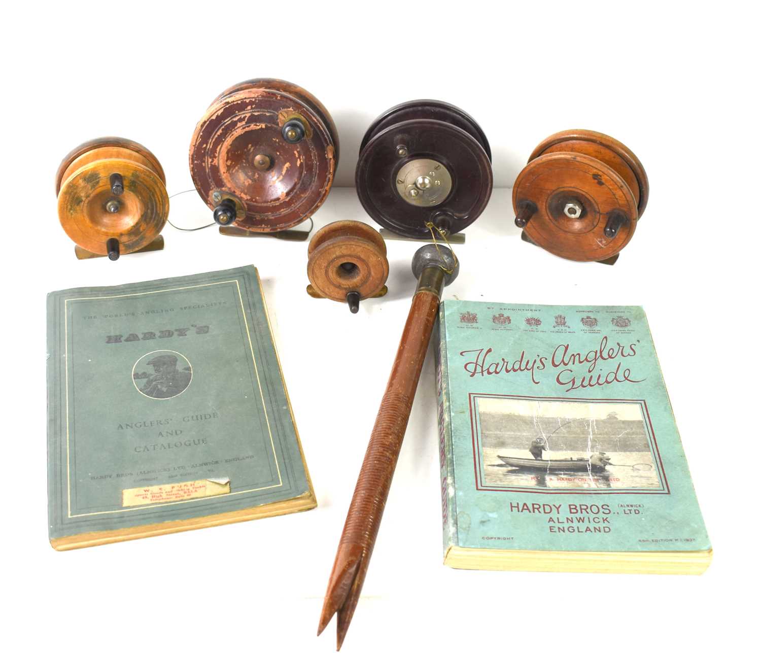 A group of wooden centrepin reels together with a Allcock Aerialite reel, two Hardy's Anglers Guides