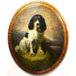 A reproduction 19th Century style oval plaque depicting portrait of a black and white spaniel,