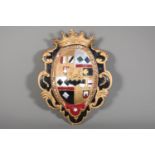 Carved and painted wood and gesso wall plaque depicting a family coat of arms, 41cm x 32cm.