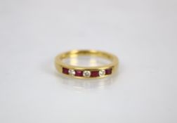 A ruby and diamond 18ct yellow gold eternity ring, ‘CJ’ Birmingham 2004, the four princess cut,