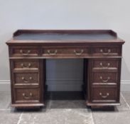 A Victorian mahogany pedestal desk, the rectangular top with three quarter gallery and leather inset