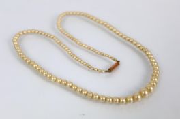 A single strand graduated simulated pearl necklace with yellow metal clasp stamped '9ct', within a