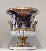 An exceptionally large Derby imari urn and integral stand, the campana shaped urn with lobed lower