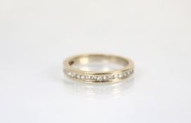 A diamond set half eternity ring, set with a single row of graduated princess cut diamonds, all