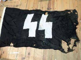WW2 German SS flag dated 1943 A rather damaged SS flag with several tears and wear holes. Some