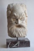 Satyr mask carved in white marble