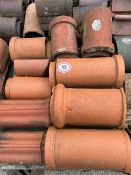 Approx. 35 assorted red ridge roof tiles inc. half round and decorative pieces