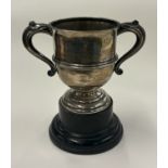 A two-handled silver trophy cup.