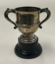 A two-handled silver trophy cup.