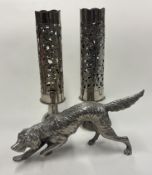 A silver-plated figure of a dog etc.