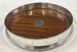 A fine quality silver-mounted mahogany magnum bottle coaster.