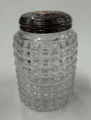 A silver-gilt-lidded glass scent bottle.