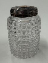 A silver-gilt-lidded glass scent bottle.