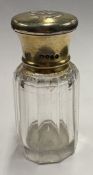 A silver-gilt-lidded glass scent bottle.
