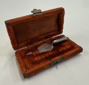 A silver bookmark in the form of a trowel.