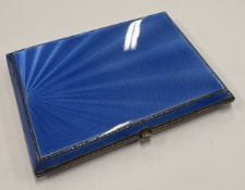 A silver and blue enamelled cigarette case.