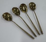 A set of four Russian silver-gilt ice cream spoons.