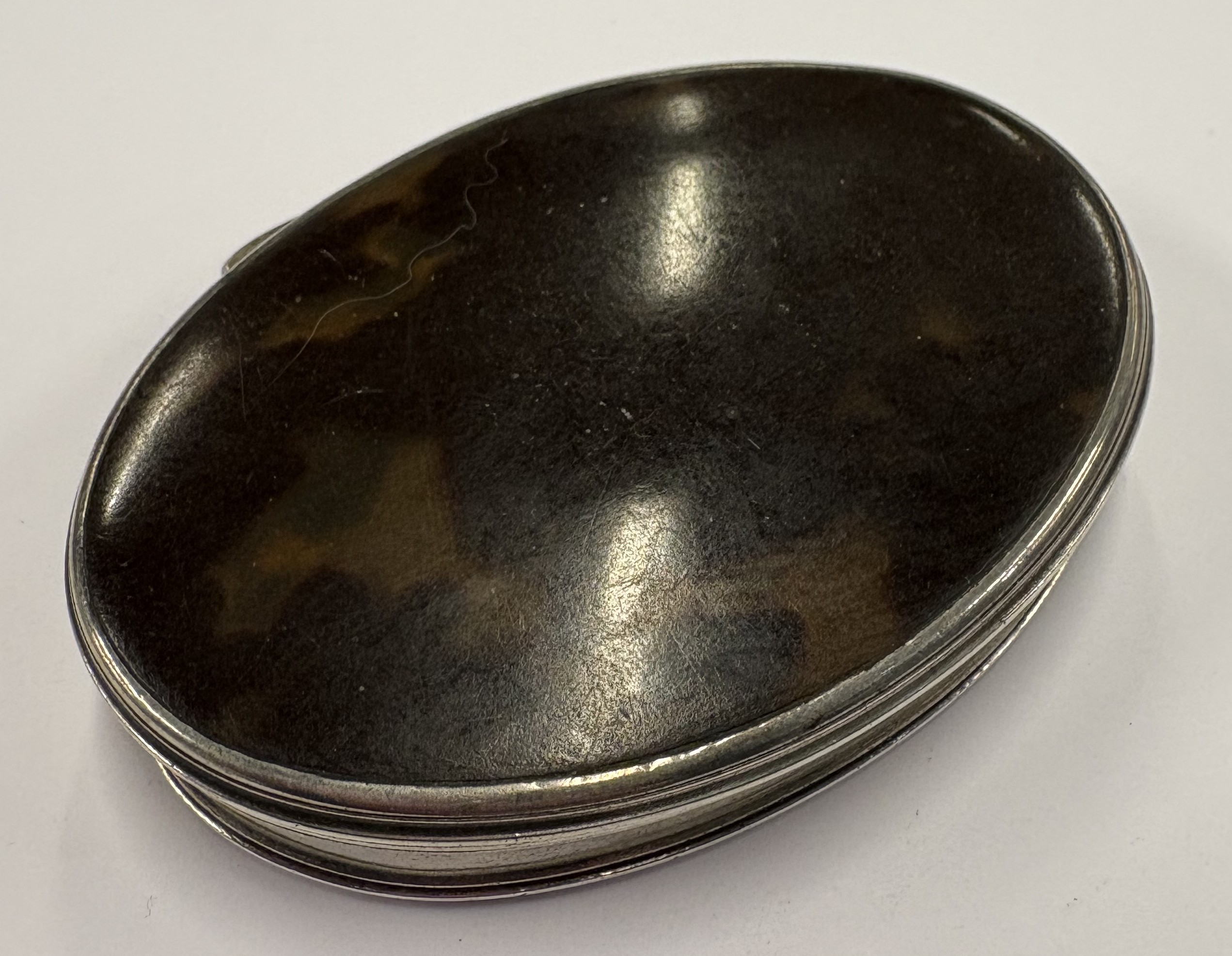 A silver and faux tortoiseshell snuff box.