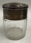 An attractive silver-gilt-mounted etched glass perfume jar.