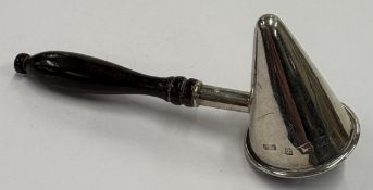 A silver candle snuffer.