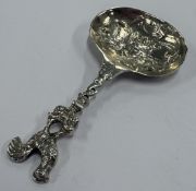 A silver caddy spoon.