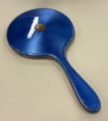 A silver and blue enamelled hand mirror.