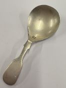 A modern silver caddy spoon.