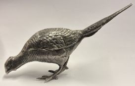 A heavy textured silver figure of a pheasant.