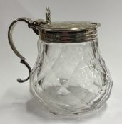 A Victorian silver-mounted glass mustard pot.