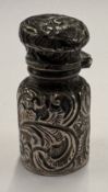 A chased silver scent bottle with hinged cover.