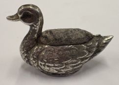 A silver pin cushion in the form of a duck.
