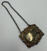 A Victorian silver wine label for 'Whiskey'.
