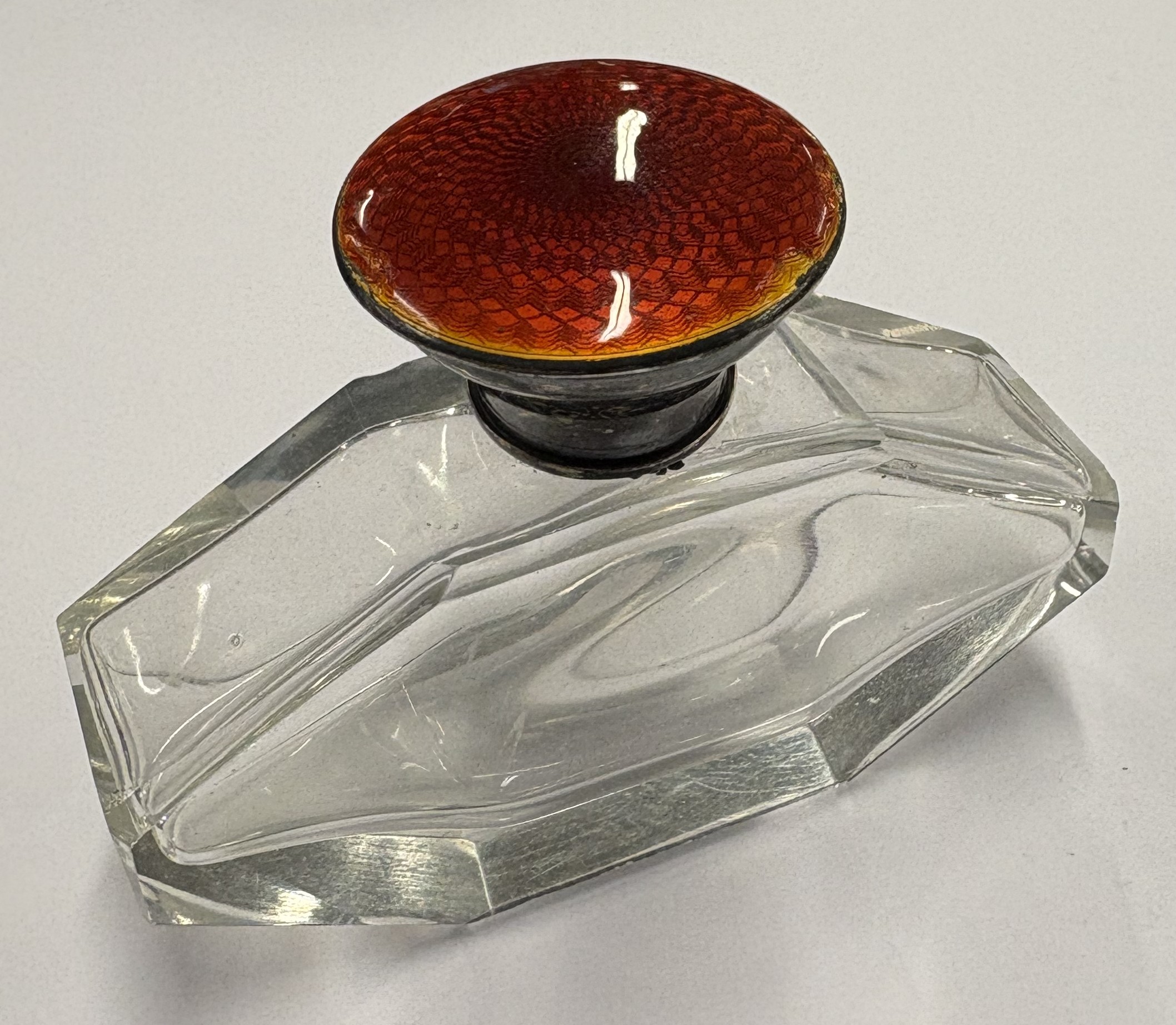 An early 20th Century silver and red enamelled glass scent bottle.