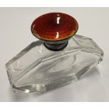 An early 20th Century silver and red enamelled glass scent bottle.