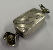 A silver pill box in the form of a sweet.