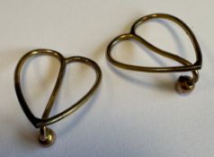 A small pair of gold-plated napkin clips.
