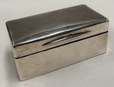 A silver combination cigar box and match striker.