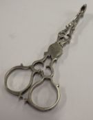 CHESTER: A pair of silver sugar nips.