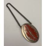A Channel Islands silver and enamelled label.