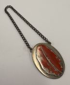 A Channel Islands silver and enamelled label.
