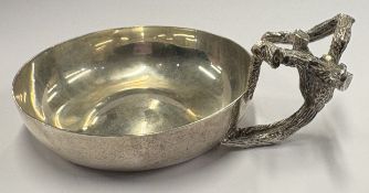A modernistic silver wine taster.