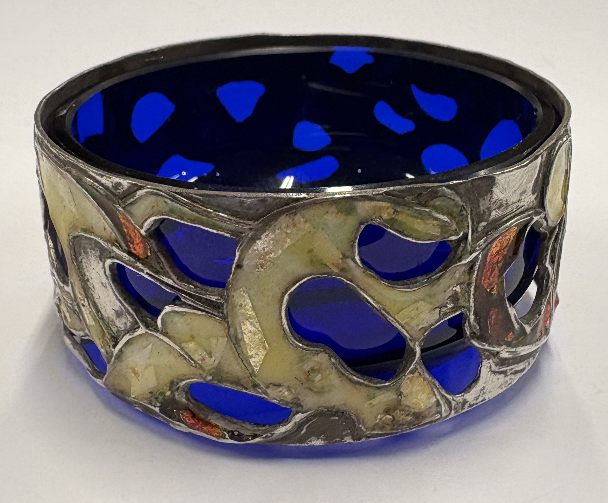 A pierced silver and enamelled salt.